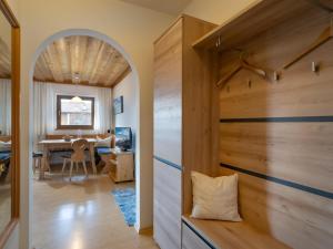 a room with a hallway with a wooden wall at Kröpflhof in Sankt Johann in Tirol