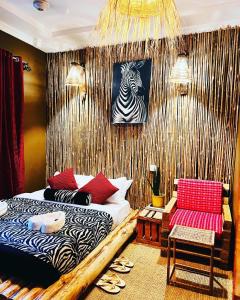 a bedroom with a bed and a zebra picture on the wall at Savannah House in Arusha
