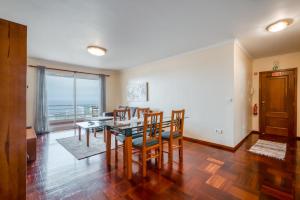 een woonkamer met een eettafel en stoelen bij Apartamento Vista Azul in Funchal