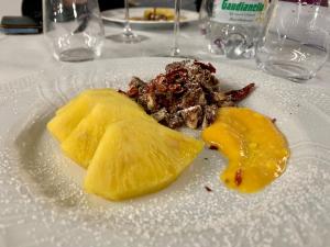 a white plate with food on a table at Hotel IL DIRETTO in Potenza