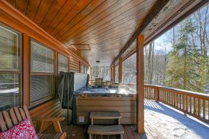 a screened in porch with a desk on a deck at Tall Oaks Retreat in McHenry