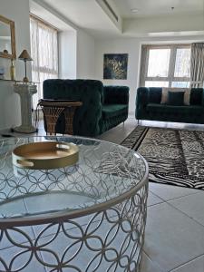a living room with a table and a couch at Serenity 3BR Palm view in Marina in Dubai