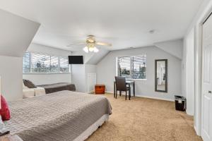 a bedroom with a bed and a chair and a desk at Large Room Near UVU & BYU in Orem