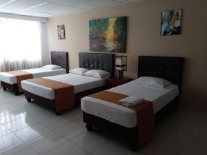 Giường trong phòng chung tại Hotel Parque del Perro