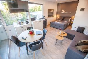 a living room with a table and a couch at Kalafatis beach home in Itea