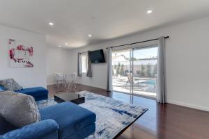 a living room with a blue couch and a sliding glass door at 5 Bedroom Charmer with Pool in Reseda