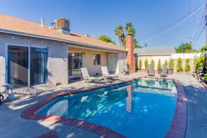 a swimming pool in front of a house at 5 Bedroom Charmer with Pool in Reseda