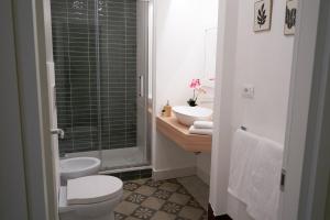 a bathroom with a toilet and a sink and a shower at Toscano Palace Luxury Rooms Catania in Catania