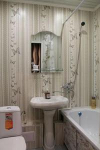 a bathroom with a sink and a toilet and a tub at 1 комн квартира в 6 мкр (Кунаева) in Uralsk