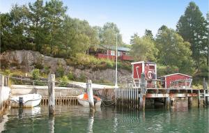 a dock with two boats tied to it in the water at Awesome Home In Sandvoll in Sandvoll