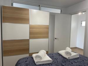 Postel nebo postele na pokoji v ubytování SAN AGUSTIN SEAVIEW BLUE APARTMENT