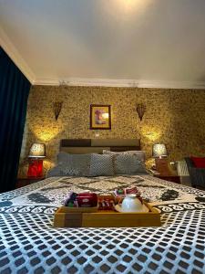 a bedroom with a large bed with a tray on it at HOTEL LYBETEN in Ferizaj