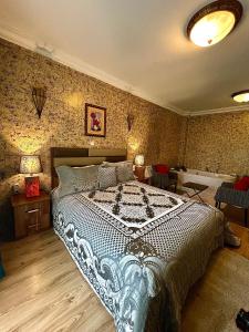 a bedroom with a large bed in a room at HOTEL LYBETEN in Ferizaj