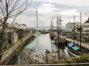 a group of boats docked in a harbor at The Old Smokehouse in St Austell