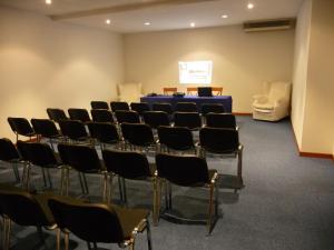 a room with chairs and a table and a screen at Hotel Villa Dei Bosconi in Fiesole