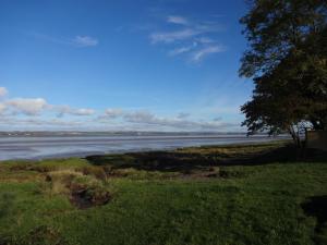 a view of a body of water with a tree at Bowness Bed & Breakfast Double Room, Bowness-on-Solway in Bowness-on-Solway