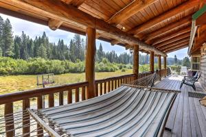 a porch with a hammock on a wooden deck at Log Home on 40 Private Acres By Mt Shasta Ski Park in McCloud