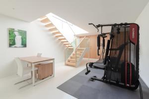 a home gym with a treadmill and a staircase at Karat Villa Macaronesia in Adeje