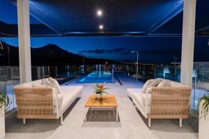 two chairs and a table in front of a swimming pool at Karat Villa Macaronesia in Adeje