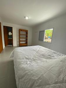 Voodi või voodid majutusasutuse Casa com 3 suítes à 500m da praia em Ilhabela toas