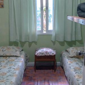 En eller flere senge i et værelse på A Casa do Chef Ubatuba