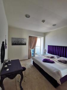 a bedroom with a large bed with a purple headboard at Serenity 3BR Palm view in Marina in Dubai