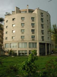 a large building in the middle of a green field at Acfes-Seiyo Hotel in Vladivostok