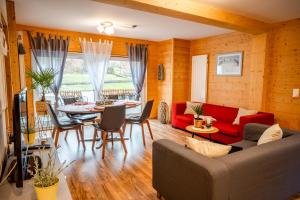 a living room with a red couch and a table at Apartments am See in Brienz