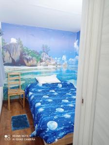 a bedroom with a mural of the ocean at Il Bungalow di Villa Mirko in Vaccarizzo - Delfino