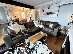a living room with a couch and a table at Cozy Cabin on the Lake w/ HotTub in Hopatcong