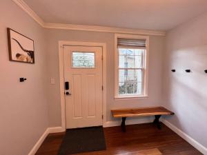 a room with a door and a bench next to a window at Cozy Cabin on the Lake w/ HotTub in Hopatcong