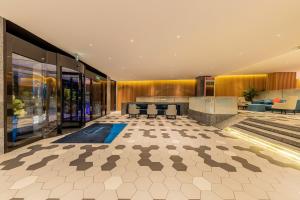 a lobby of a building with chairs and tables at Holiday Inn Express Yichang Riverside, an IHG Hotel in Yichang