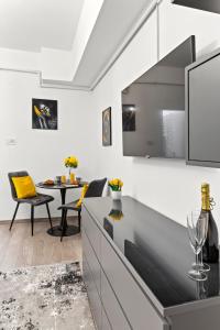 a kitchen and dining room with a tv and a table at Brand New Studio - Old Town in Bucharest