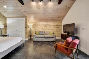a bedroom with a bed and a tv and a couch at The SoCo Studio by Lodgewell - 2 cute 2 b 4 gotten in Austin