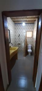 a bathroom with a sink and a toilet at Sénégal CASAMANCE in Boukot Ouolof
