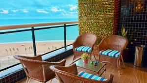 a balcony with chairs and a view of the beach at LANDSCAPE - Beira mar platinum in Fortaleza