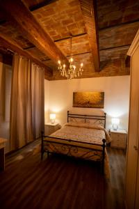 a bedroom with a bed and a chandelier at Le stanze dei Ghibellini in Florence