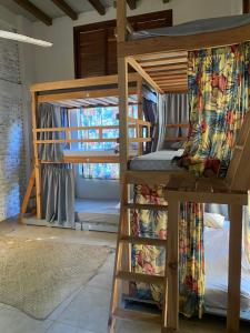 a bunk bed in a room with a bunk bed in a room at La Palmera Hostel in Puerto Escondido +4 photos