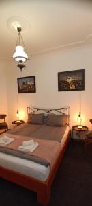 a bedroom with a bed with two tables and two lamps at Authentic Belgrade Centre Hostel - Only private rooms in Belgrade