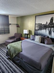 a hotel room with a large bed and a couch at Bison Plains Lodge in Moorhead