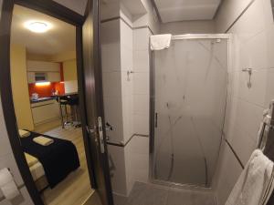 a shower with a glass door in a bathroom at NA BYSTRYM in Zakopane +106 photos