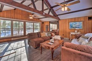 a living room with couches and a ceiling fan at Rustic Lake Harmony Home with Fire Pit and Hot Tub! in Lake Harmony