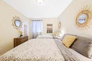 a bedroom with two beds and a mirror at Dapper Digs - King Bed - Long Term Stays - Duke in Durham