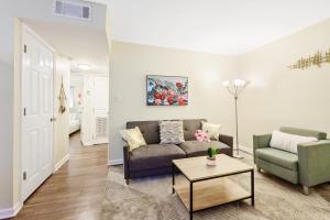 a living room with a couch and a table at Dapper Digs - King Bed - Long Term Stays - Duke in Durham