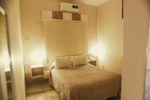 1 dormitorio pequeño con 1 cama con 2 almohadas en Alas Hotel en San Rafael
