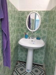 a bathroom with a sink and a mirror at Dar Hkaïem in Hammam Sousse