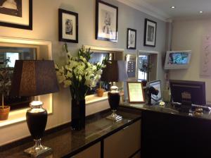 an office with a desk with flowers and a lamp at Hotel Tiffany in Copenhagen