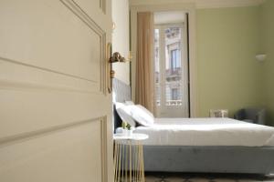 a bedroom with a bed and a mirror at Toscano Palace Luxury Rooms Catania in Catania