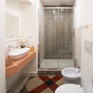 a bathroom with a shower and a sink and a toilet at Toscano Palace Luxury Rooms Catania in Catania