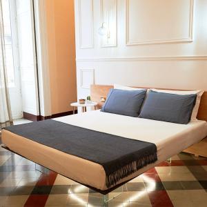 a bedroom with a bed in a room at Toscano Palace Luxury Rooms Catania in Catania